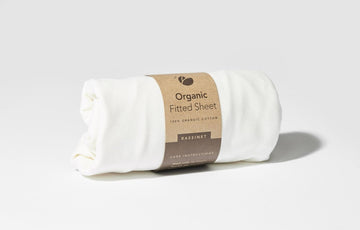 Lotus Bassinet Fitted Sheet rolled up in packaging